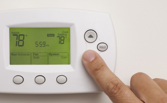 Digital Thermostat with a male hand, set to 78 degrees Fahrenheit. Saved with clipping path for thermostat and hand combined.